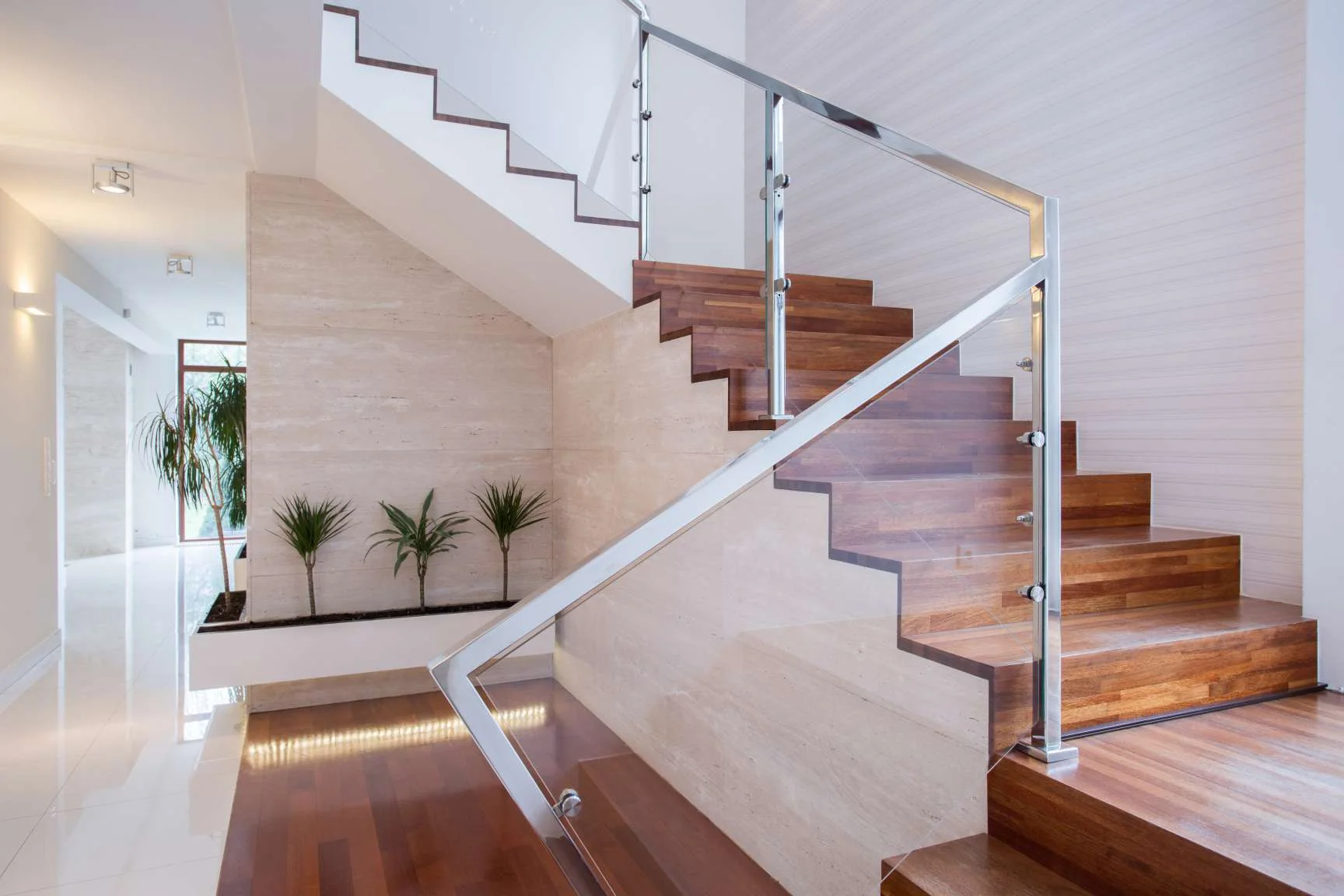 dark wood bespoke staircase London with steel handrail and glass panels